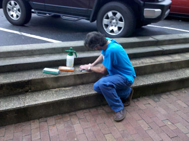 Using the great outdoors to clean up sharpening stones.